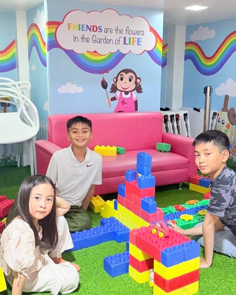 Children building towers from giant coloured blocks
