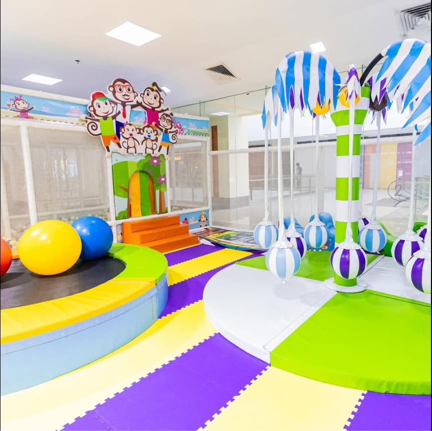 The padded softplay area with a trampoline and swinging balls