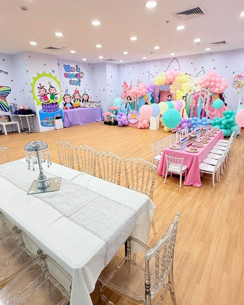 A pastel-themed party room set up for a birthday celebration